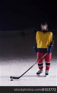 young teen girl ice hockey player portrait on training in black background