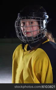 young teen girl ice hockey player portrait on training in black background