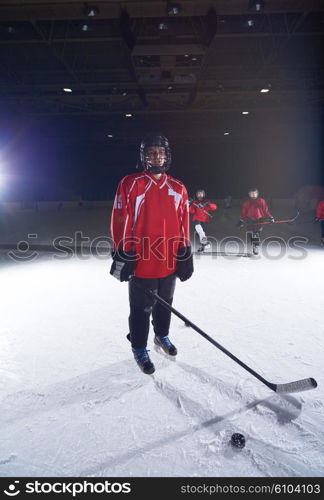 young teen girl ice hockey player portrait on training in black background