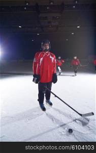young teen girl ice hockey player portrait on training in black background