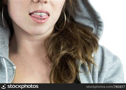 Young teen girl with tongue piercing and hoodie isolated. Young teen girl with tongue piercing and hoodie