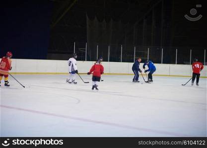 young teen, girls ice hockey players team group meeting with trainer in sport arena indoors