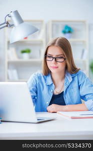 Young teenage female student preparing for exams at home