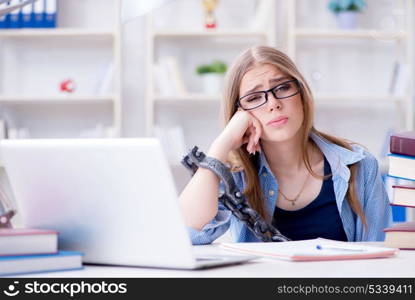 Young teenage female student preparing for exams at home
