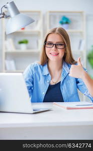 Young teenage female student preparing for exams at home