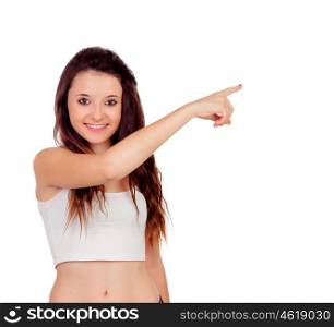 Young teenage girl pointing at something with his index finger