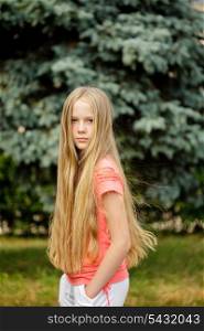 Young teenage long-hair blonde girl is posing outdoor