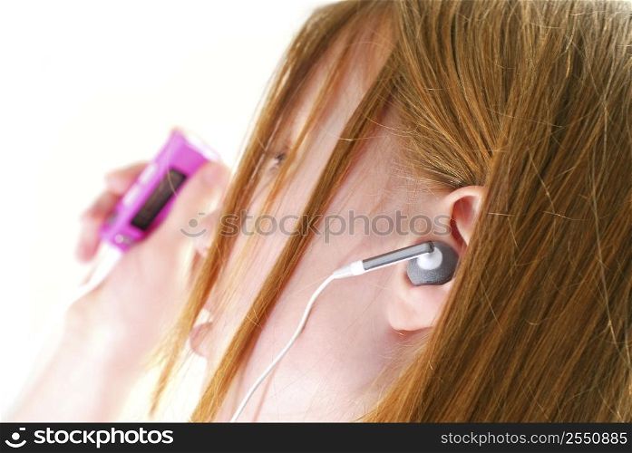 Young teendage girl listening to music on her mp3 player