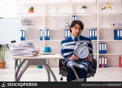 Young tied male employee in the office 