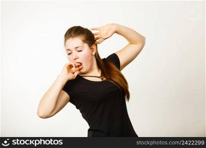 Young tired attractive woman having brown hair yawning covering mouth with hand feeling exhausted.. Young tired woman yawning