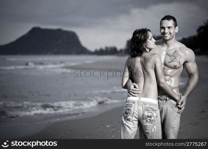 Young topless couple on beach