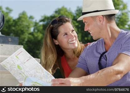 young tourist couple with map outdoors