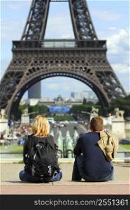 Young tourists enjoying the view of Eiffel tower in Paris, France.
