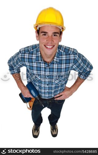 Young tradesman holding a power tool