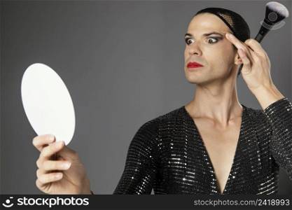 young transgender person looking into mirror front view