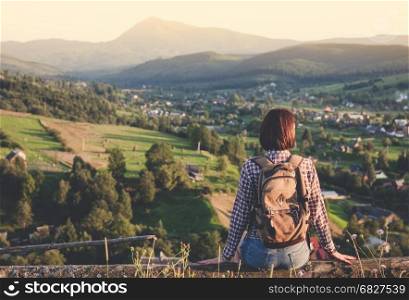 Young travel girl enjoying mountain view
