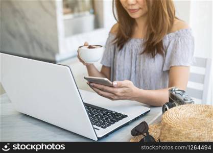 Young traveler planning vacation trip and searching information or booking hotel on laptop and smartphone, Travel concept