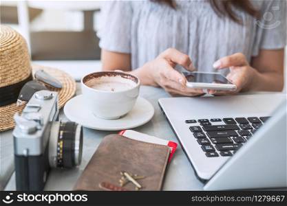 Young traveler planning vacation trip and searching information or booking hotel on laptop and smartphone, Travel concept