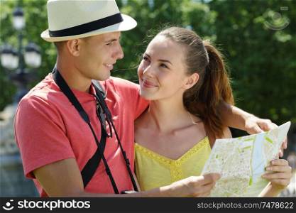 young traveling couple checking the map