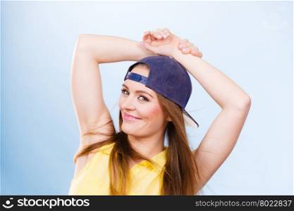 Young trendy smiling female dancer.. Healthy lifestyle. Happiness and joy. Young smiling fashionable girl in motion. Joyful sporty female teenager in jeans cap dancing.