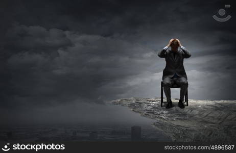 Young troubled businessman with hands on his head