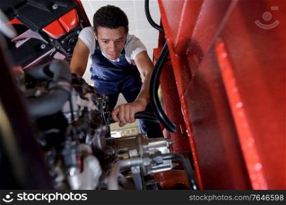 young truck mechanic at work