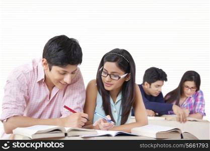 Young university students studying in classroom