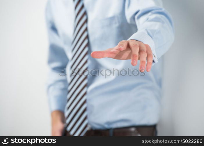 Young unrecognizable business man touching virtual button. Editable image