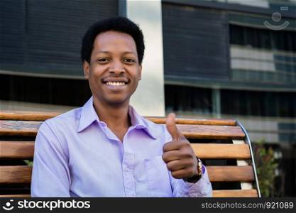 Young urban businessman giving thumb up. Successful businessman.