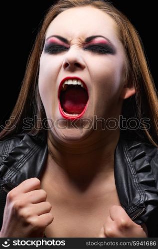 Young vampire girl isolated on black
