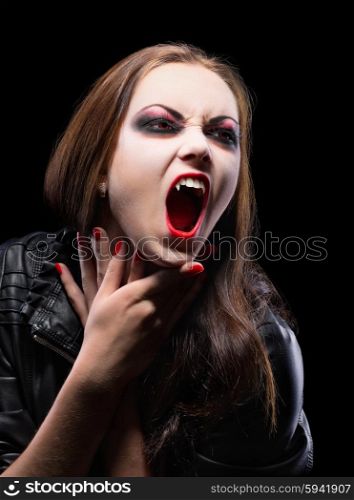 Young vampire girl isolated on black