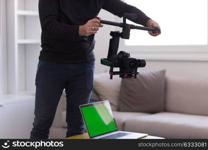 young videographer with gimball video slr at work