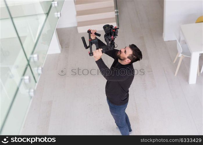 young videographer with gimball video slr at work