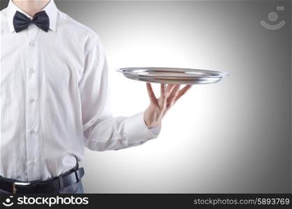 Young waiter with silver tray