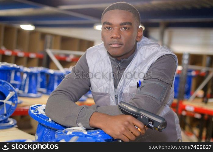 young warehouse worker scanning