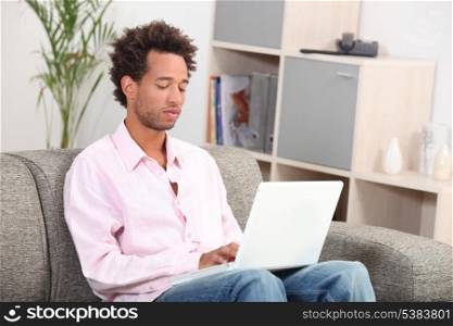 young with computer in living-room