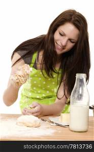 young woman adding flour to dough. happy young woman adding flour to dough on white background
