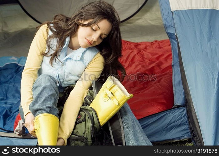 Young woman adjusting her galoshes