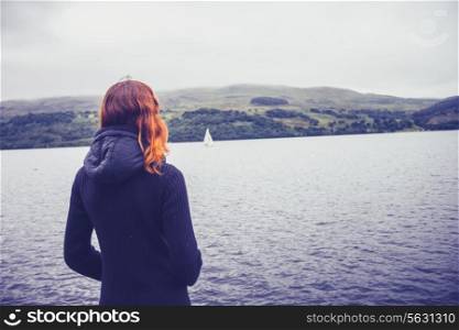 Young woman admiring the stillness of a lake