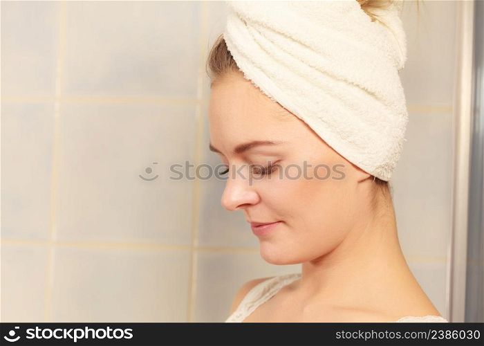 Young woman after morning shower in a bathroom, beautuful female wrapped turban towel. woman in towel on her head in bathroom