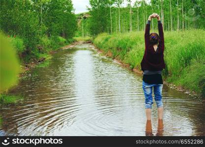 Young woman alone in a river