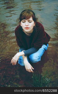 Young woman alone in a river