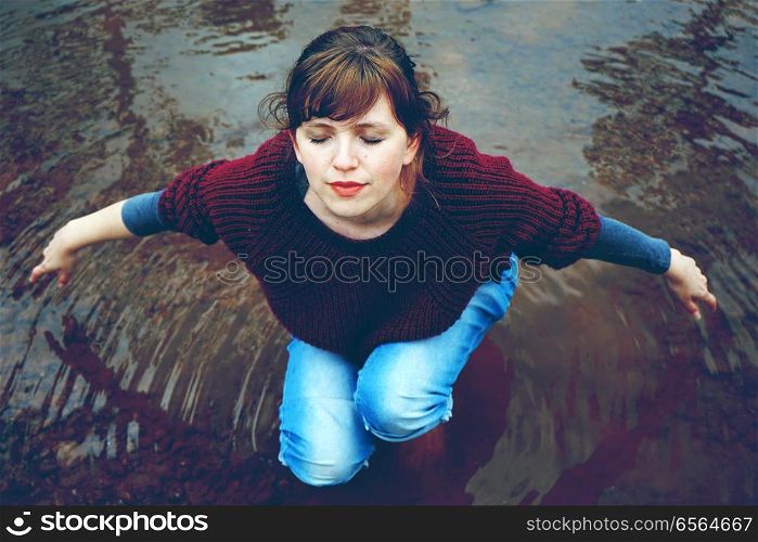 Young woman alone in a river