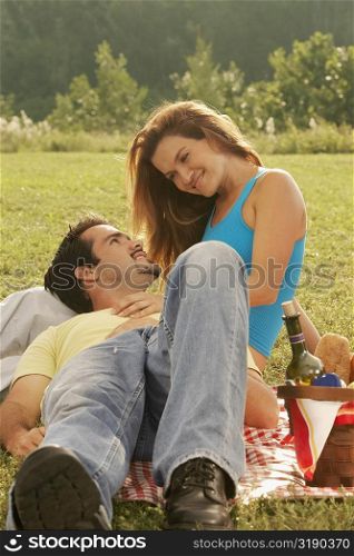 Young woman and a mature man at a picnic