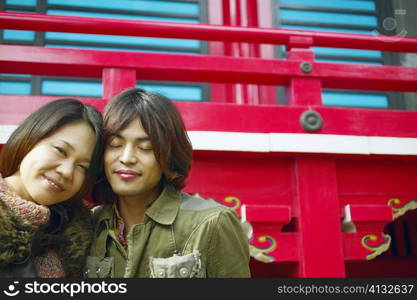 Young woman and a mid adult man sitting together