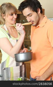 young woman and companion tasting dish