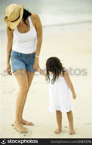 Young woman and her daughter on the beach