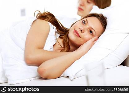 Young woman and her husband in a bed
