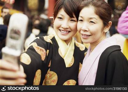 Young woman and her mother taking a photograph of themselves