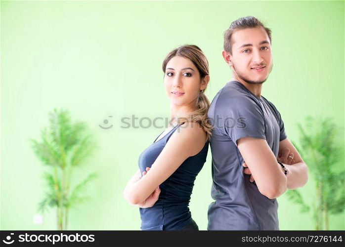 Young woman and man in sports gym